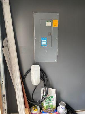 flush mounted tesla charger next to the breaker panel.