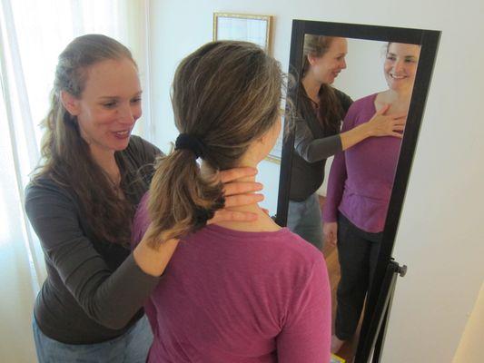 Putting hands on gently. In this way, I find out how and where my student holds tension and encourage her to let go.