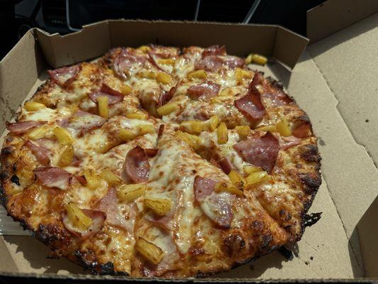 Pineapple and ham deep pan cooked well done.