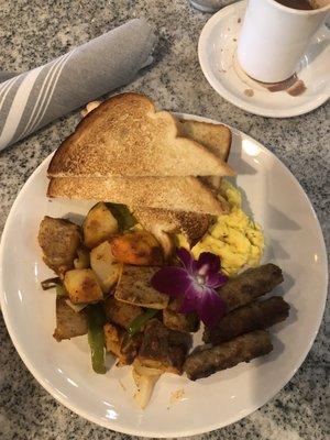 Three egg breakfast with sausage and potatoes