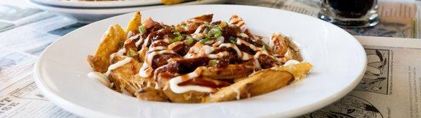 Wilbur's Favorite! Scoop fries with melted cheese, BBQ pulled pork, sour cream and onion