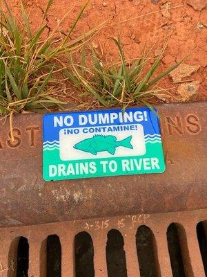 New storm drain labels as an environmental reminder not to pollute our waterways.