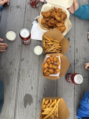 Fried cod, fries, tots, and tartar sauce.