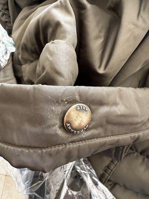 Damaged fabric around the buttons