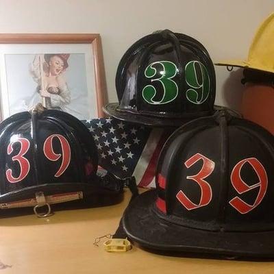 a helmet line up of some custom hand painted numbers
