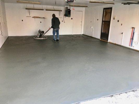 Terry puts the finishing touches on my garage floor with a power trowel. He stayed past dark working to get it perfect.