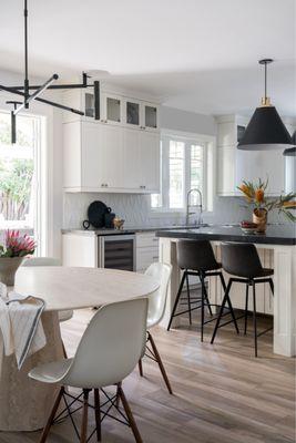 Arhaus Modina travertine table & Gage black counter stools.