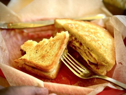 Combo Breakfast Sandwich with bacon, egg & cheese on toasted sourdough.