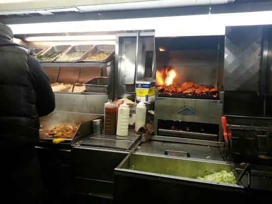 Flame grilled sauteed chicken, with peppers, then grilled on flat top to be cut and seasoned with their success/herbs