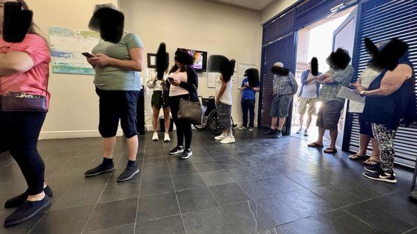 Line of people who are waiting to check in at San Tan location