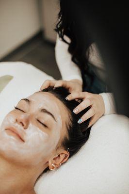 Our esthetician Lauren is giving our lovely client a scalp massage.