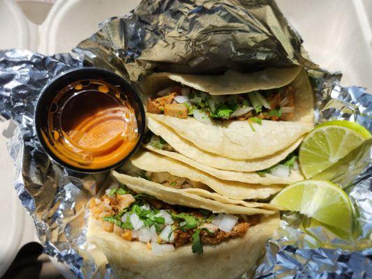 Two chicken and two carnitas tacos.