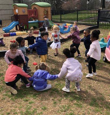 Gross motor play- regularly scheduled outdoor play, plus a gym for inclement weather. Separate playgrounds for different age levels.