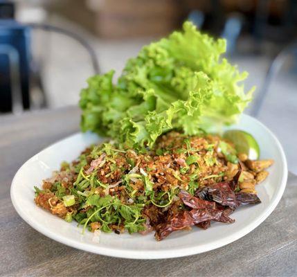 Nam Khao: Lao Crispy Rice w/ cured pork, roasted peanuts, dried chili peppers, lettuce ($16)