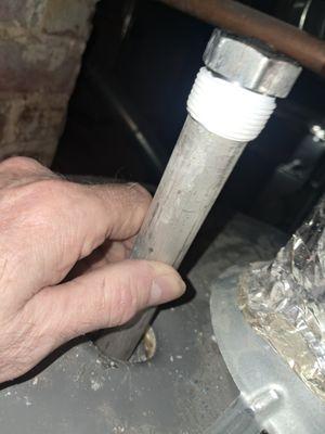 Installation of a replacement anode rod.