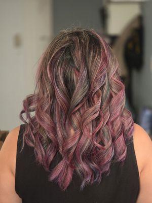 Reds, purple with a tint of green with a full highlight and haircut.