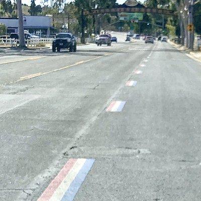 Red, white & blue lane marker stripes in the city of Norco.