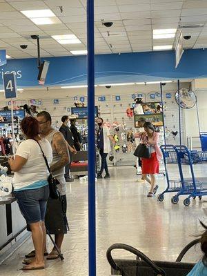 Two employees just in a row talking instead of giving great customer service do better Ross lady and white sweater gentleman and black.