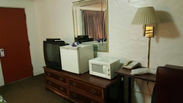 TV, Mini Fridge, and Microwave on top of dresser.
