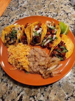 Taco Plate. From left to right: chorizo, chicharron, fajita, and two al pastor