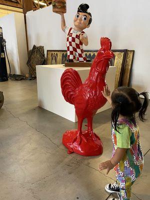 Petting a giant rooster