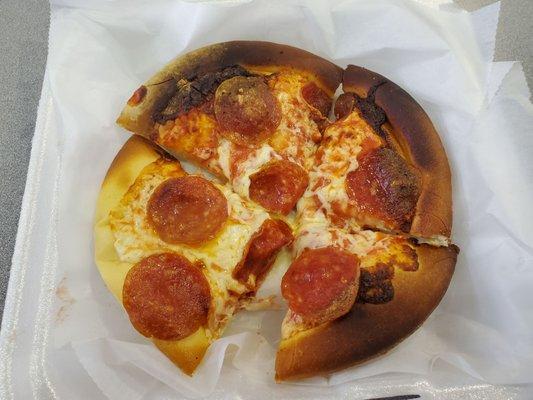 An $8 pizza at Gateway Grille in Bishop Airport. Burnt and yet a slice is still undercooked. Reminds me why I never get food at this airport