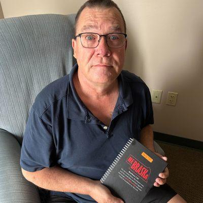 Home Care client with a gift- a Nebraska Notebook.