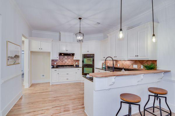 Gorgeous oak floors and custom cherry bar top.