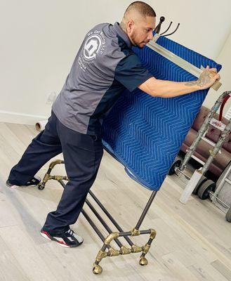 Erick is wrapping one of our customers clothes rack.