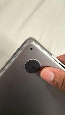 Dented MacBook with a missing screw