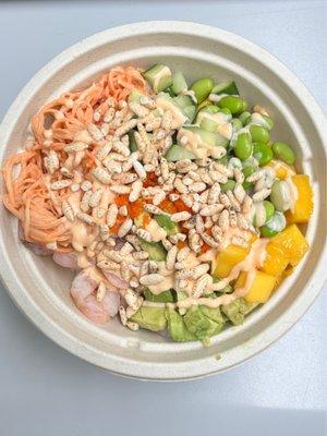 Create a bowl with shrimp and crab salad over white sushi rice. Avocado, mango, edamame, masago and crispy rice.