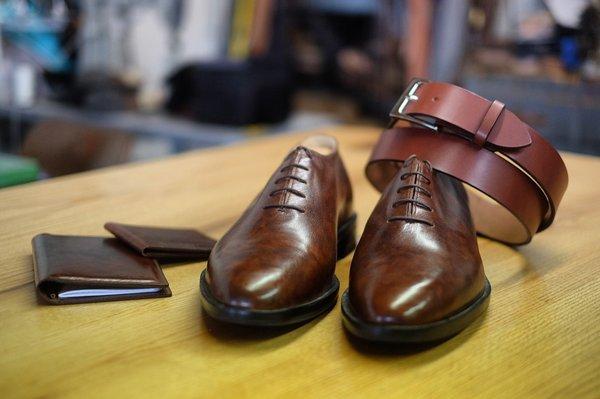 Handmade shoes, belt, wallet and journal in marbled whiskey