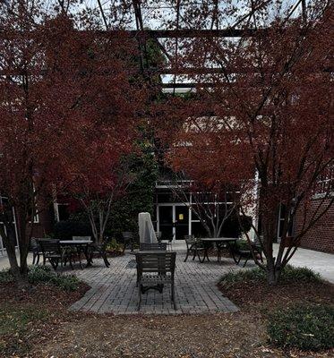Common area with seatings and big mature trees for shade