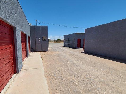 Roll-up door unit behind secure fencing and combo lock gate, Drive-up access.