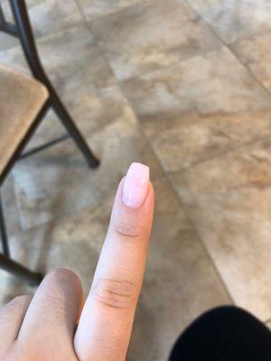 You can see how the nail is not filed down to the same length from left to right.