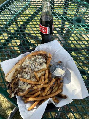 Philly cheesesteak with poblano cheese sauce.