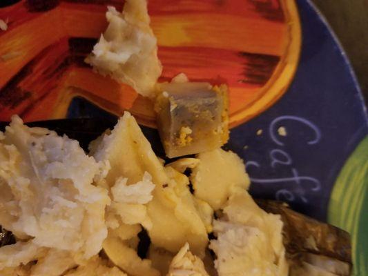 I think that dark thing is supposed to be a piece of potato.