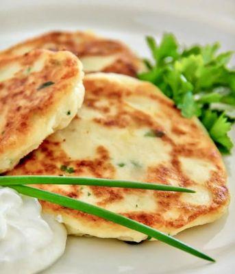 Healthy potato option - potato pancakes served with green onions and sour cream