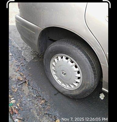 Tire that security claimed was flat. It's still attached to the tow truck and hadn't even been put in the yard yet