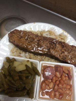 Meatloaf over rice with green beans and pinto beans.
