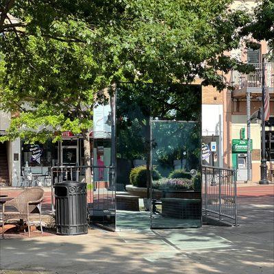 There are bathrooms past all the shops at the town square (with a splash pad) in the mirrored boxes.