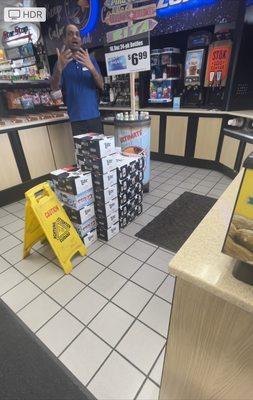 Attendant coming from behind the counter to approach me.