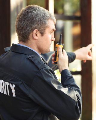 Uniformed Skyhigh Security guard standing at the entrance of a California cannabis dispensary, ensuring safety and compliance.