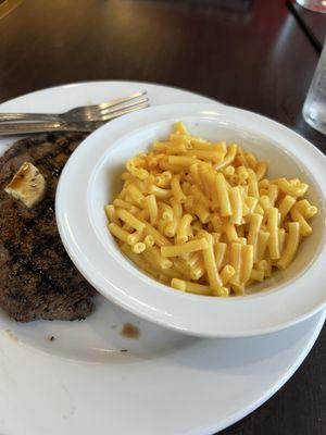 Sirloin steak and side of Mac n cheese (Kraft boxes?)