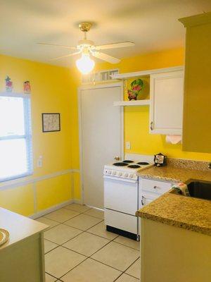 Fully stocked kitchen with oven/stove, full size refrigerator, microwave, and coffee maker.