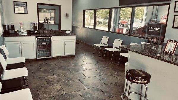 Clean waiting area with a view of the service bays.