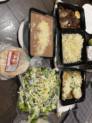 Birria, chicken, refried beans, rice, tortillas, Cobb salad