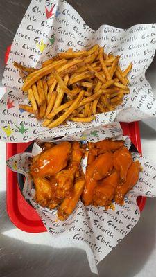 Saucy crispy and delicious buffalo hot and mango habanero wings with freshly cut seasoned fries