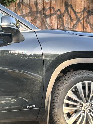 Graffiti filled parking lot full of people fighting overnight. The young woman was not safe by herself.