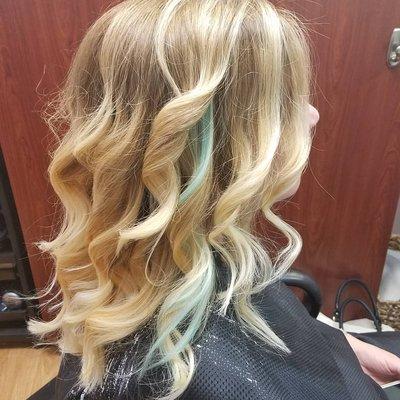 Balayage blonde with a teal extension piece